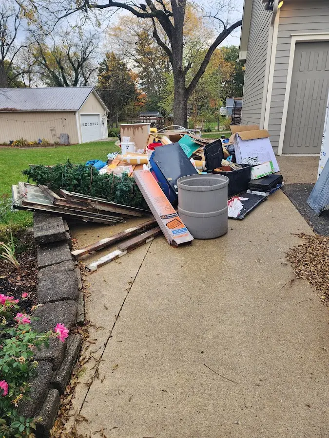 Dumpster being loaded with debris for Estate Cleanout Dumpster Rental in Idabel